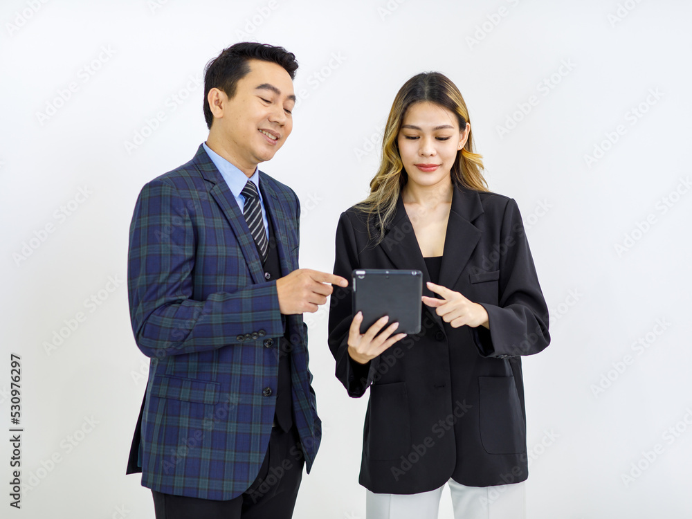 Millennial Asian cheerful successful professional male businessman manager female businesswoman colleague in formal suit standing smiling holding using tablet computer together on white background