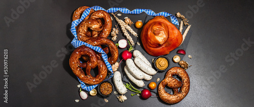 Traditional Oktoberfest set. Pretzels, smoked pork knuckle eisbein with hop © FuzullHanum