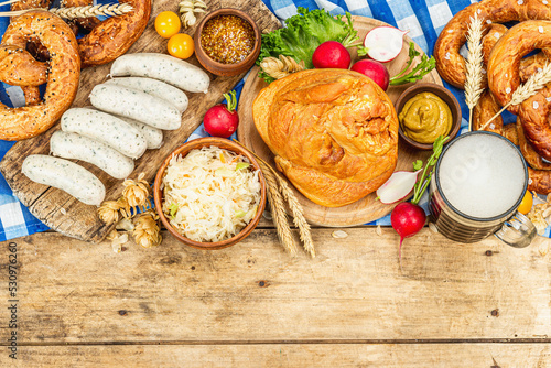 Traditional Oktoberfest set. Pretzels, beer, weisswurst, smoked pork knuckle eisbein with cabbage