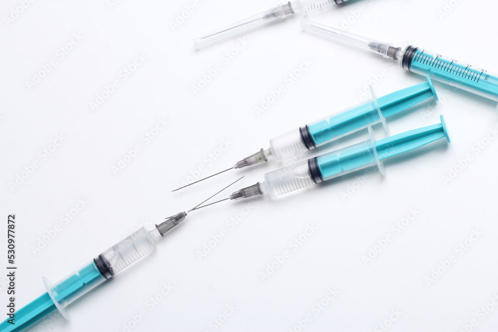 Medical syringe on a white background. A syringe for injection. The concept of health and beauty Medical syringe on a white background. A syringe for injection. The concept of health and beauty