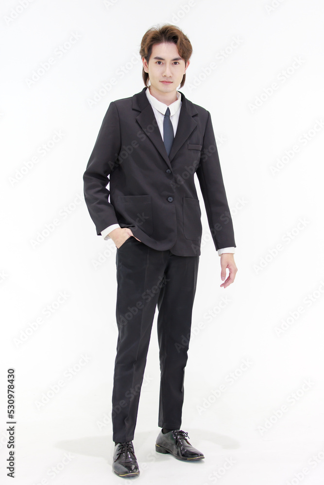 Portrait isolated cutout studio shot of Millennial Asian smart handsome successful professional male businessman in formal suit standing posing smiling put hand in pants pocket on white background Portrait isolated cutout studio shot of Millennial Asian smart handsome successful professional male businessman in formal suit standing posing smiling put hand in pants pocket on white background