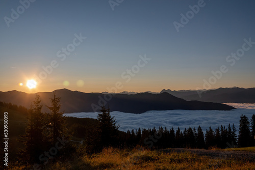 beautiful sunrise on the mountains with view of the alps and a misty valley at  autumn morning