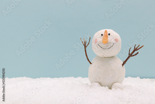 Fototapeta snowman on snow on blue background