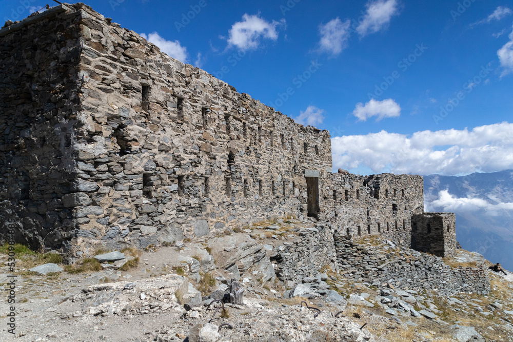 Ruins of Fort Malamot at Lake Montcenis (Moncenisio) on the border between Italy and France. Old ancient historical fort ruins in stone in the Alps mountains
