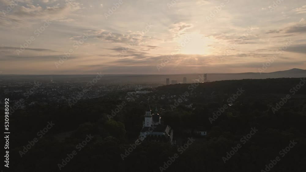 Late evening Drone approach view of the Church at Kreuzberg with backdrop of the setting sun Late evening Drone approach view of the Church at Kreuzberg with backdrop of the setting sun