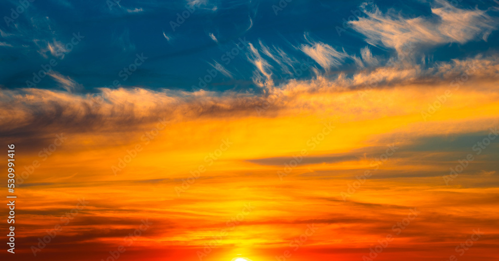 Beautiful orange clouds in blue sunset sky