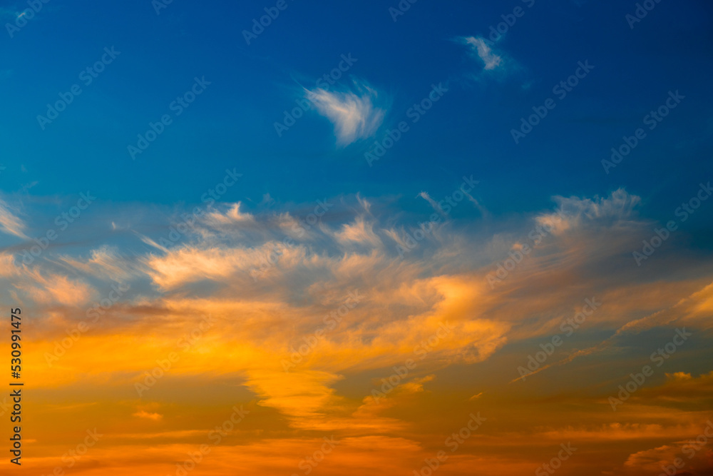 Beautiful yellow clouds in blue sunset sky