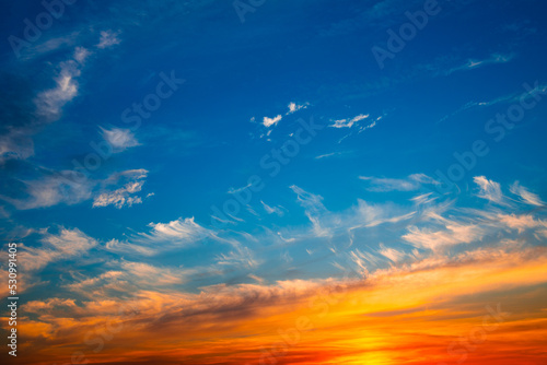Beautiful orange clouds in blue sunset sky