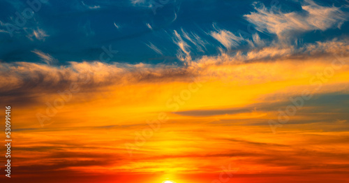 Beautiful orange clouds in blue sunset sky