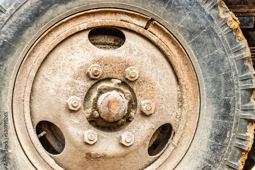 Wheel of an old truck close-up. Rusted rim. photo