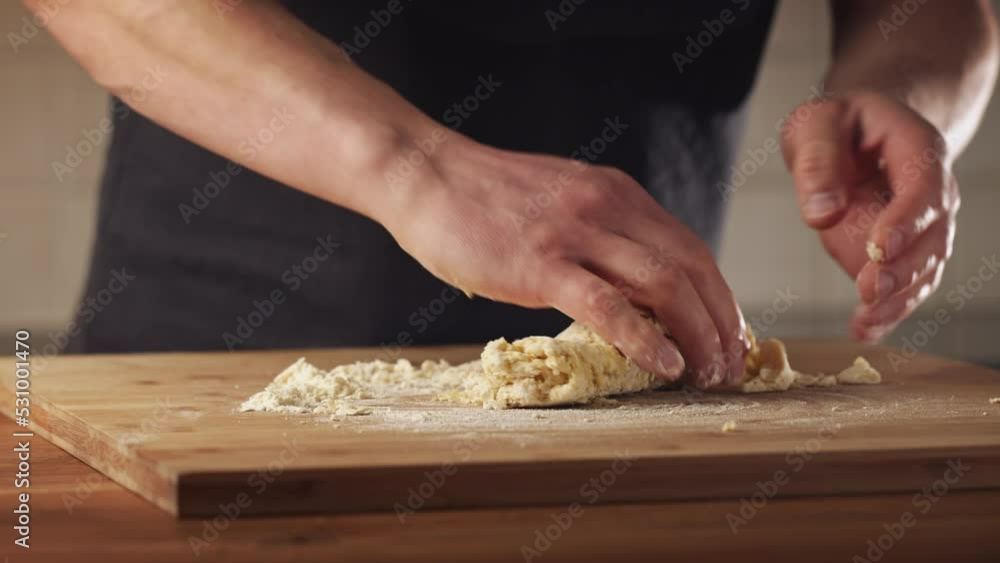 Closeup shot of a man making fettuccine Alfredo at home. Home cooking concept. Kneading dough by hand. Closeup shot of a man making fettuccine Alfredo at home. Home cooking concept. Kneading dough by hand.