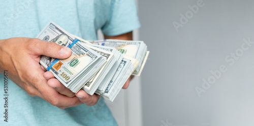Man of hundred dollar bills close up. Stock market financial illegal freedom exchange earn pile rich present gift employer prepayment service gratitude concept photo