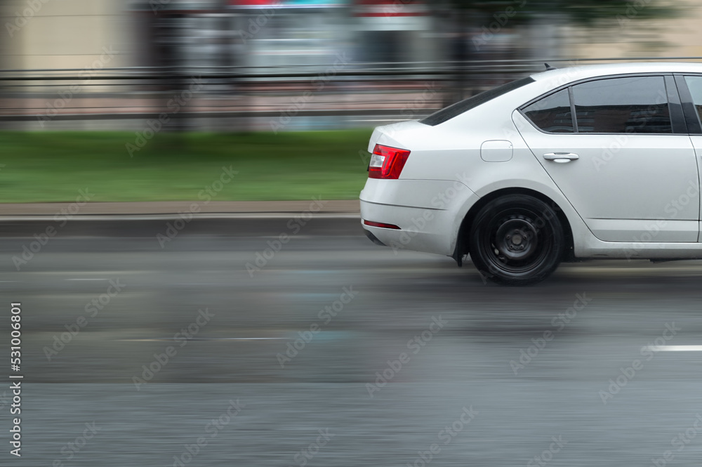 white car on a city street in a motion blur with copy space