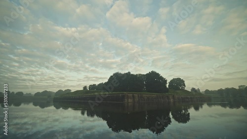 POV walking shot along the outside walls of the fortified historic town of Naarden, Netherlands by sunrise. photo