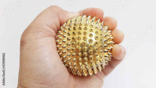 Handheld magnetic thorn ball health therapy device isolated on white background