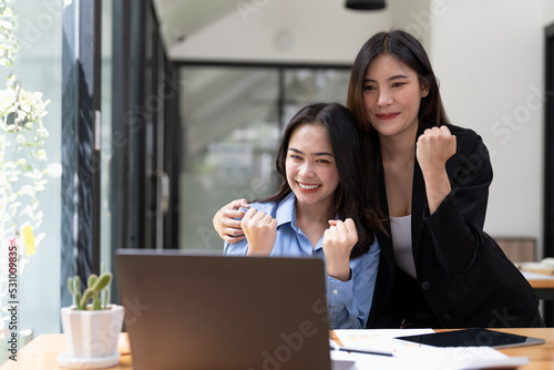 Group of Young Asian business team creative businesspeople coworker in office Happy to be successful partnership teamwork celebrating achievement and success concept.