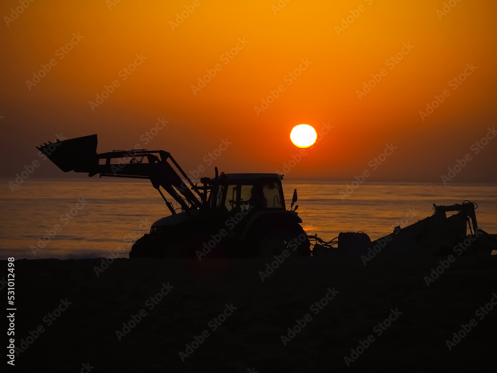 A tractor at sunset, symbolizing energy and the sun