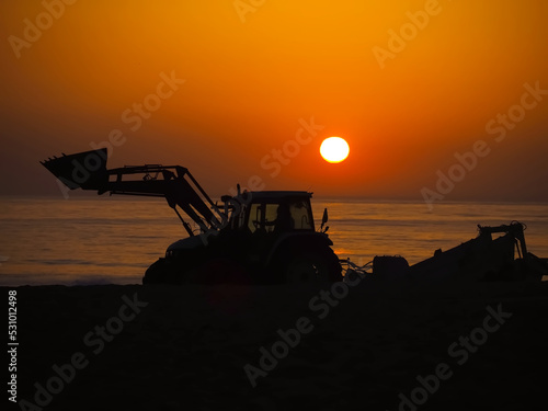 A tractor at sunset, symbolizing energy and the sun