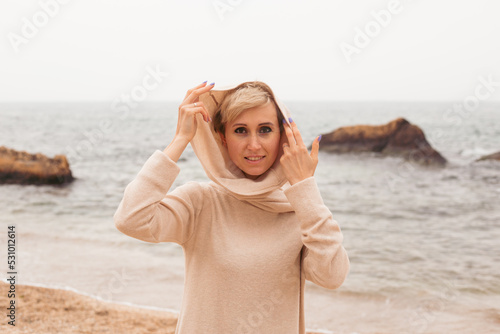 portrait of woman on sandy beach near sea, closeup
