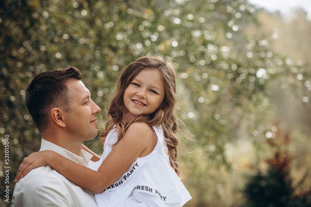 Family father and daughter are beautiful and happy together, in white clothes, in nature Family father and daughter are beautiful and happy together, in white clothes, in nature