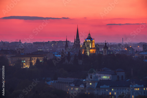 Majestic sunset over Lviv city  Ukraine. St. George s Cathedral backlighted in the dusk. Silhouettes of spires of St. Elizabeth Church. Picturesque fire sky