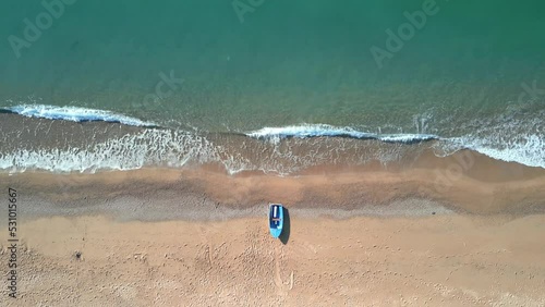 Naira Aerial image of Malgrat de Mar beach in Barcelona aerial shot Costa del Maresme small blue fisherman's boat photo