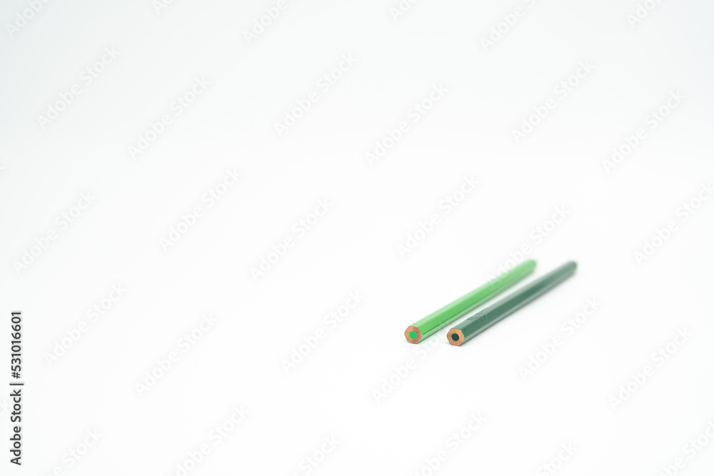 green wooden colored pencil on a white background with end part in focus green wooden colored pencil on a white background with end part in focus