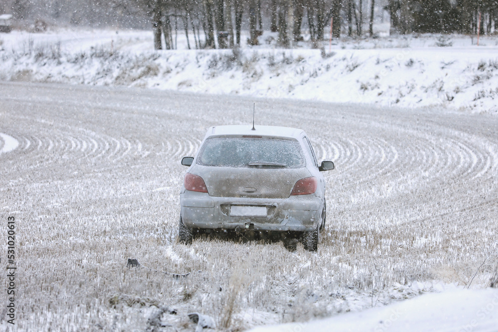 Wrecked Car in Stubble Field in Winter Snowfall, copy space for your text. 