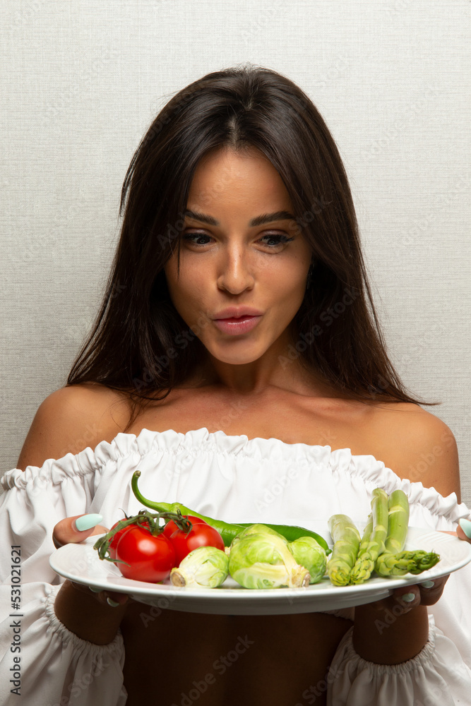 Beautiful girl with a dish of vegetables. Beautiful girl with a dish of vegetables.