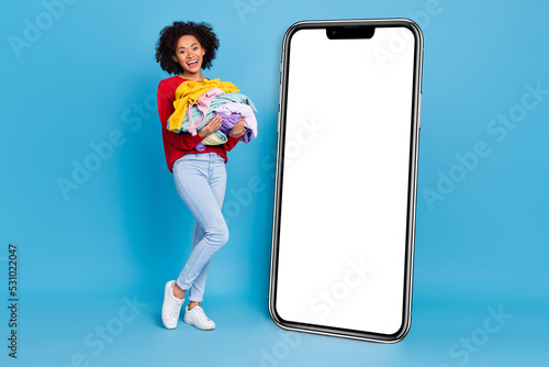 Photo of funny funky young lady dressed red pullover holding large staff stack empty space isolated blue color background