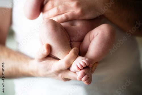 Father holding Lovely infant foot 