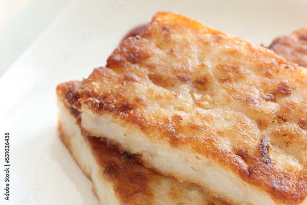 Chinese food, Pan fried radish cake on dish with sweet chili sauce for yum cha food image Chinese food, Pan fried radish cake on dish with sweet chili sauce for yum cha food image