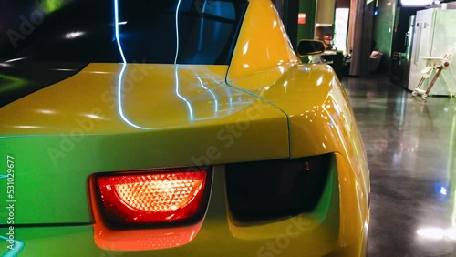 Sports Car Taillight Movie Hero Yellow. High quality 4k footage. exhibition tuning garage power stand booster spoiler