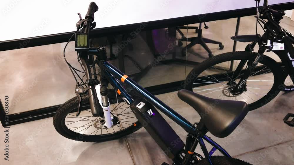 Bicycle with electric traction rechargeable battery auxiliary on the frame. High quality 4k footage. bike shop accessories new technology