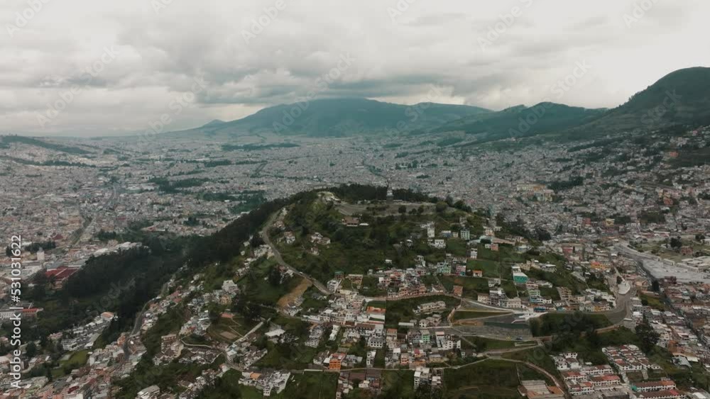 El Panecillo Mountain Peak Towering In The City Center Of Quito, Ecuador. Aerial Wide Shot El Panecillo Mountain Peak Towering In The City Center Of Quito, Ecuador. Aerial Wide Shot