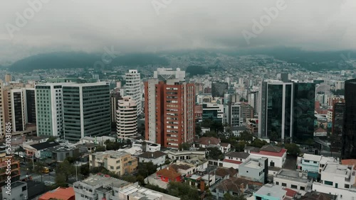 High-rise Apartment Buildings In Quito City With Mountains Shrouded By Fog In The Background In Ecuador. - aerial ascend