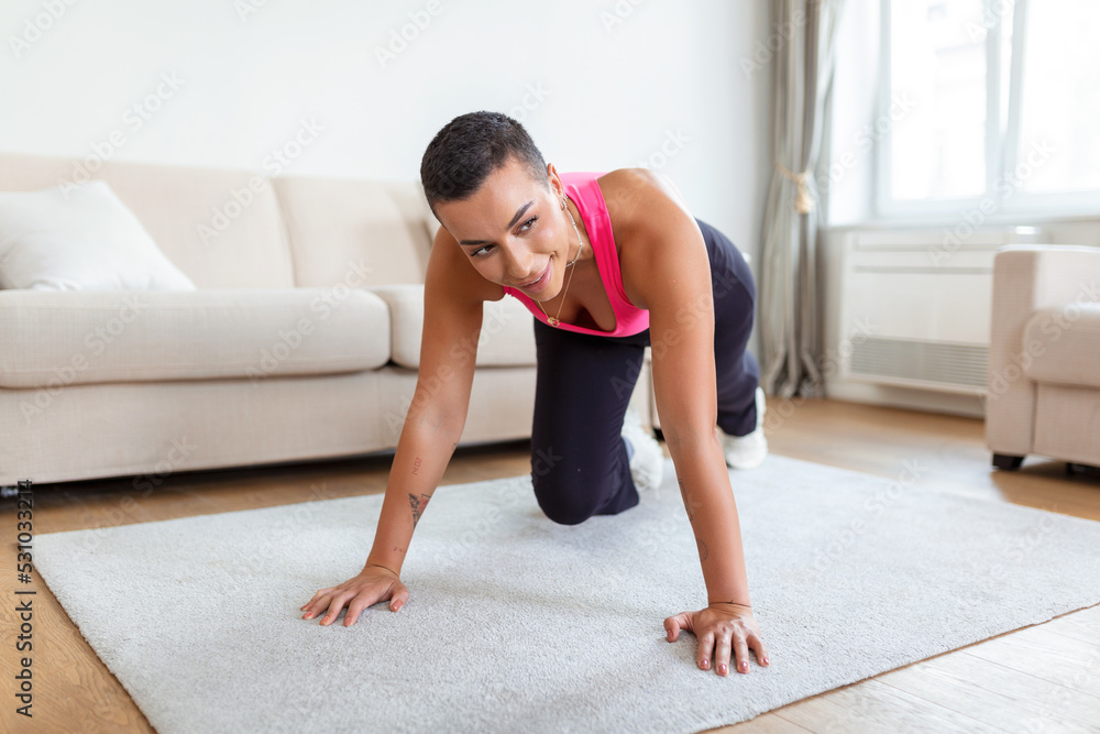 Workout Routine. Fit active athletic black woman doing mountain climbers exercise on yoga mat, strong sporty female in sportswear training abs core muscles in gym, fitness studio or at home Workout Routine. Fit active athletic black woman doing mountain climbers exercise on yoga mat, strong sporty female in sportswear training abs core muscles in gym, fitness studio or at home