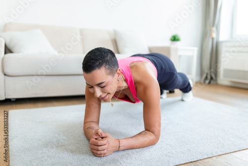 Healthy Lifestyle Concept. African American Lady Standing In Plank Position On Yoga Mat At Home Or Fitness Studio. Cheerful Female In Sportswear Training Core And Abs Muscles