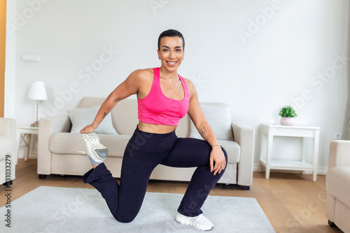 Warming Up Before Workout. Smiling Sporty Black Woman Training At Home Or Fitness Club Studio, Beautiful Female Stretching Legs After Exercises On Mat