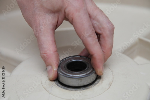 Washer machine drum new bearing installation when replacement. Front load washing machine repair photo