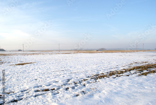 Winter view of the field. Snow on the grass. Countryside in Poland © Monika