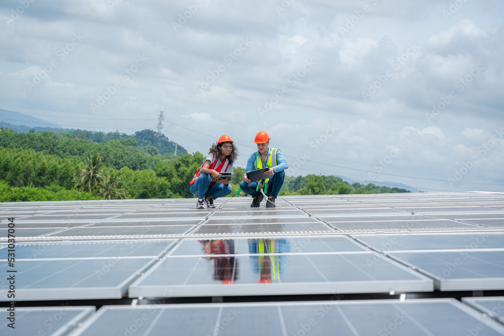 Engineers checking the operation of the system solar cell on roof at factory,Alternative energy to conserve the world's energy,Photovoltaic module idea for clean energy production. Engineers checking the operation of the system solar cell on roof at factory,Alternative energy to conserve the world's energy,Photovoltaic module idea for clean energy production.