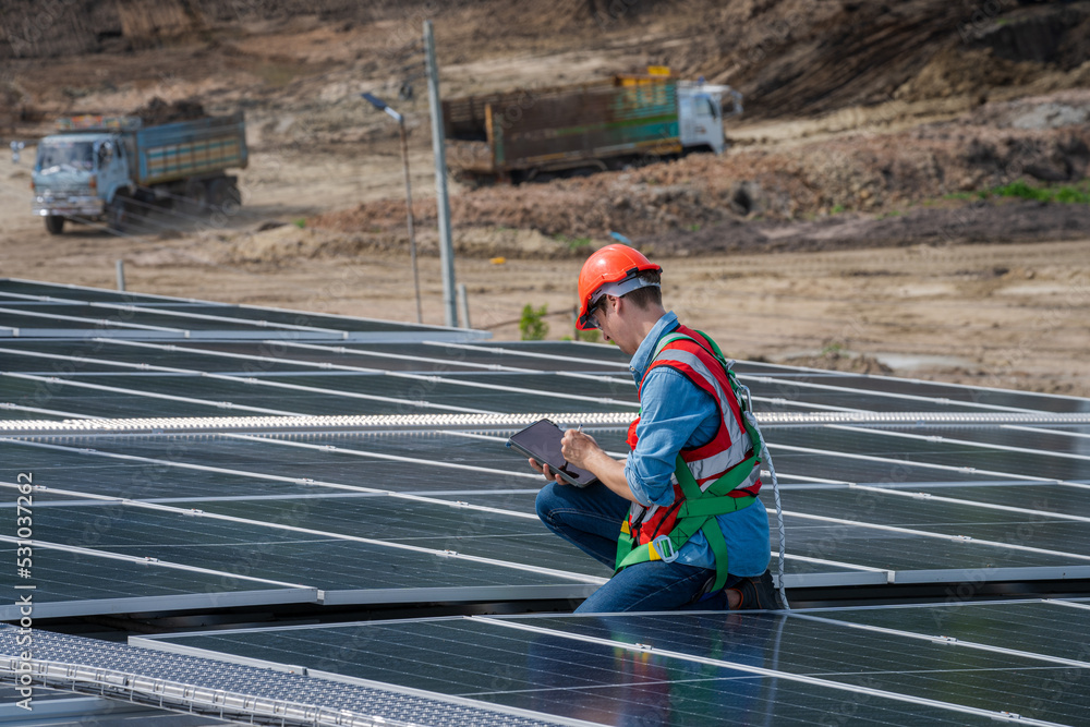 Engineers checking the operation of the system solar cell on roof at factory,Alternative energy to conserve the world's energy,Photovoltaic module idea for clean energy production. Engineers checking the operation of the system solar cell on roof at factory,Alternative energy to conserve the world's energy,Photovoltaic module idea for clean energy production.