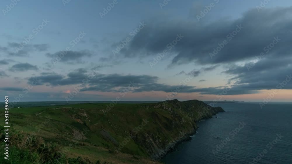 Day to night time lapse at the Pembrokeshire Coast National Park with impressive cloud formations over the sea, Wales, United Kingdom Day to night time lapse at the Pembrokeshire Coast National Park with impressive cloud formations over the sea, Wales, United Kingdom