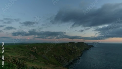 Day to night time lapse at the Pembrokeshire Coast National Park with impressive cloud formations over the sea, Wales, United Kingdom photo