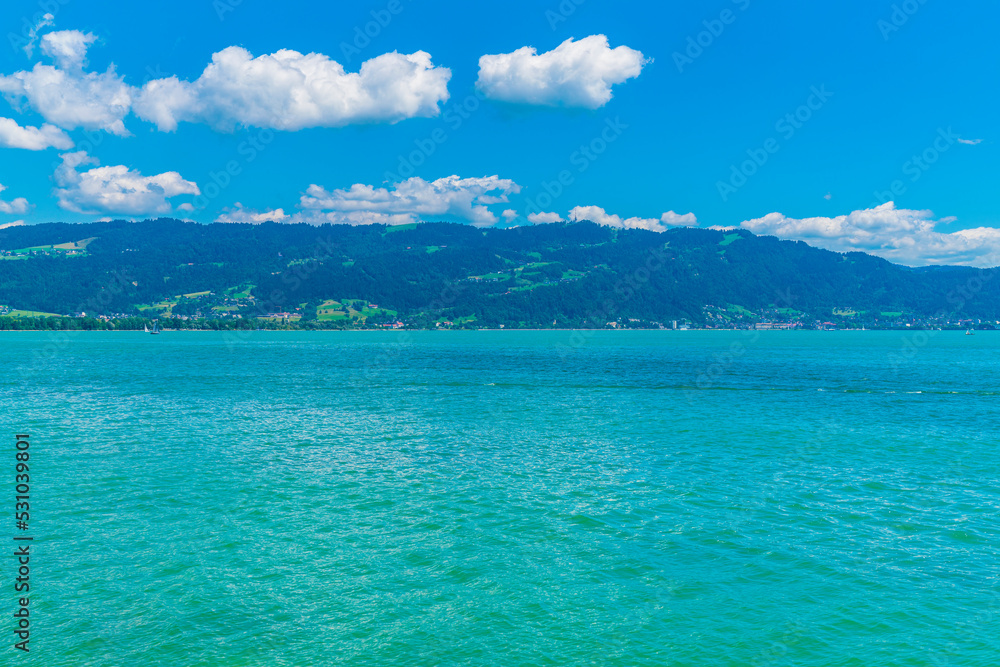 Germany, Beautiful panorama view above lakeside of turquoise bodensee lake water at austria coast and bregenz city, pfaender mountain