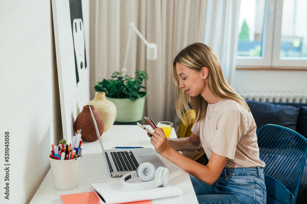 teenager female sitting desk in her room and shopping online