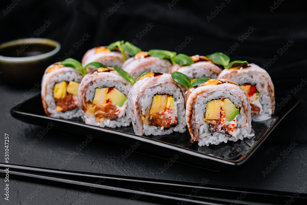 Eel sushi rolls on black plate Eel sushi rolls on black plate