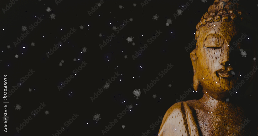 Naklejka premium Image of snow falling over buddha on black background