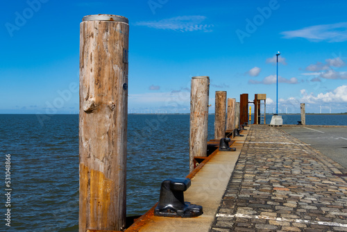 Wooden pillar or mooring post along a quay in a harbor
